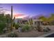 Desert home with a paver driveway, well-manicured desert landscaping, and a charming entrance at 10596 E Yearling Dr, Scottsdale, AZ 85255