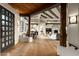 Spacious foyer featuring hardwood floors, exposed wood beams, and seamless transition to the dining and living areas at 10596 E Yearling Dr, Scottsdale, AZ 85255