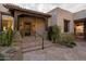 Inviting front entrance with a tiled roof, stone accents, desert landscaping, and secure gate at 10596 E Yearling Dr, Scottsdale, AZ 85255