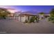 Beautiful home with a three-car garage, paver driveway, and desert landscaping at 10596 E Yearling Dr, Scottsdale, AZ 85255
