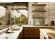 Modern kitchen featuring sleek countertops, custom cabinetry, and a window with scenic mountain views at 10596 E Yearling Dr, Scottsdale, AZ 85255