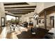 Spacious living room featuring exposed beams, a fireplace, and scenic views from the large window at 10596 E Yearling Dr, Scottsdale, AZ 85255
