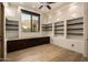Charming office area with built-in shelves, storage cabinets, wood floors, and a window view at 10596 E Yearling Dr, Scottsdale, AZ 85255