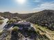Elevated view of a beautiful hillside home featuring a tile roof, desert landscaping, and a private pool at 11320 N Crestview Dr, Fountain Hills, AZ 85268