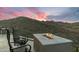 An outdoor fire pit area with chairs overlooking the desert landscape, perfect for cozy evenings and gatherings at 11320 N Crestview Dr, Fountain Hills, AZ 85268