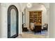 Inviting living room showcases a custom bookshelf, neutral furniture and elegant lighting with arched doorway and pillars at 11320 N Crestview Dr, Fountain Hills, AZ 85268