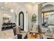 A bright living room with stylish seating, arched doorway, and views of the dining area, showcasing an open floor plan at 11320 N Crestview Dr, Fountain Hills, AZ 85268