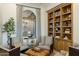 Bright living room features custom bookshelves, comfortable seating area and large view window with desert views at 11320 N Crestview Dr, Fountain Hills, AZ 85268