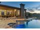 Backyard with a luxurious pool and spa, complete with a cozy fire pit area for relaxation and entertainment at 11320 N Crestview Dr, Fountain Hills, AZ 85268