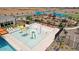Aquatic park featuring a beach-style zero-entry pool, splash pad and play structures, fenced for safety at 11943 E Aster Ln, Florence, AZ 85132