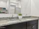 Bathroom with a double sink vanity with granite countertop and ample lighting at 11943 E Aster Ln, Florence, AZ 85132