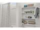Clean and bright bathroom with shower, built-in shelves, and decorative accents at 11943 E Aster Ln, Florence, AZ 85132