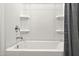 Brightly lit white bathtub with a chrome faucet and shower head at 11943 E Aster Ln, Florence, AZ 85132
