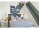Stylish bedroom with a modern light fixture, accent wall, plush bedding, and coordinated decor at 11943 E Aster Ln, Florence, AZ 85132