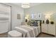 Bright bedroom featuring a patterned accent wall and stylish decor at 11943 E Aster Ln, Florence, AZ 85132