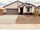 Charming single-story home featuring a two-car garage and low maintenance desert landscaping at 11943 E Aster Ln, Florence, AZ 85132