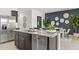 Open-concept kitchen featuring stainless steel dishwasher and sink, a large island, and modern appliances at 11943 E Aster Ln, Florence, AZ 85132
