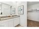 Bright bathroom featuring double sinks, granite countertops, walk-in closet, and decorative accents at 11959 E Aster Ln, Florence, AZ 85132