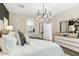 Modern bedroom with en suite bathroom, featuring neutral tones, chic furnishings, and natural light at 11959 E Aster Ln, Florence, AZ 85132