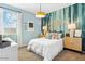Light and airy bedroom featuring light blue walls, decorative accents, and large windows at 11959 E Aster Ln, Florence, AZ 85132