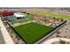 This image shows the pristine community center amenity lawn with picnic tables and manicured landscaping at 11959 E Aster Ln, Florence, AZ 85132