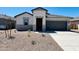 Beautiful single-story home features a modern elevation, complemented by a well-maintained desert landscape and inviting curb appeal at 11959 E Aster Ln, Florence, AZ 85132
