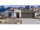Charming single-story home with well-manicured landscaping and a two-car garage and mountain backdrop at 11959 E Aster Ln, Florence, AZ 85132