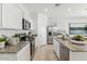 Modern kitchen with stainless steel appliances, granite countertops, and ample cabinet space at 11959 E Aster Ln, Florence, AZ 85132