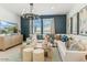 Bright, stylish living room featuring a large sectional, modern lighting, and beautiful decor at 11959 E Aster Ln, Florence, AZ 85132