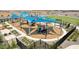 Community playground featuring a variety of play structures with safety surfacing and perimeter fencing at 11959 E Aster Ln, Florence, AZ 85132