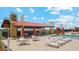 Inviting poolside lounge area with comfortable seating and shade, perfect for relaxation and socializing at 11959 E Aster Ln, Florence, AZ 85132
