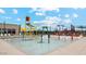 Community splash pad with colorful play features and lounge chairs offers a fun, relaxing environment at 11959 E Aster Ln, Florence, AZ 85132