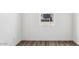 Neutral bedroom with wood-look floors and window view of neighboring home at 12443 E Bahia Ct, Florence, AZ 85132
