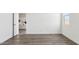 Well-lit bedroom featuring wood-look floors, white walls, and an open doorway at 12443 E Bahia Ct, Florence, AZ 85132