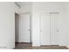 Clean bedroom with closet and two doors, all painted in white color at 12443 E Bahia Ct, Florence, AZ 85132
