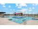 A community pool complex offers a variety of aquatic activities, including lap lanes, splash pad, and lounging areas at 12443 E Bahia Ct, Florence, AZ 85132