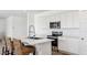 Well-equipped kitchen featuring modern appliances, an island, and bar stool seating for a casual dining space at 12443 E Bahia Ct, Florence, AZ 85132