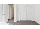 Bright bedroom featuring closet with sliding doors and an open door into another area at 12456 E Bahia Ct, Florence, AZ 85132