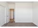 Clean bedroom with neutral carpet and an open door into another room at 12456 E Bahia Ct, Florence, AZ 85132