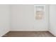 A clean bedroom featuring neutral carpet, white walls, and natural light through a window at 12456 E Bahia Ct, Florence, AZ 85132