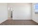 Bedroom with carpet flooring and a view into an ensuite bathroom at 12456 E Bahia Ct, Florence, AZ 85132