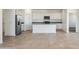 Spacious kitchen with tiled floors, white cabinets, and stainless steel appliances, providing a modern feel at 12456 E Bahia Ct, Florence, AZ 85132