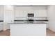 Modern kitchen with white cabinets, stainless steel appliances, and granite countertops, creating a sleek look at 12456 E Bahia Ct, Florence, AZ 85132
