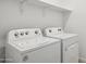 Functional laundry room featuring a Whirlpool washer and dryer set, with an overhead shelf at 12456 E Bahia Ct, Florence, AZ 85132