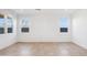 Bright living room with two windows offering natural light and neutral tile floors at 12456 E Bahia Ct, Florence, AZ 85132