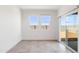 Neutral living area featuring a sliding glass door and two windows at 12456 E Bahia Ct, Florence, AZ 85132
