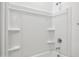An alcove shower with a chrome shower head and built-in shampoo shelves at 12456 E Bahia Ct, Florence, AZ 85132