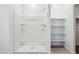 Clean, bright shower with built-in shelves and a white surround at 12456 E Bahia Ct, Florence, AZ 85132
