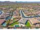 Aerial view of a residential neighborhood featuring pools, new grass and desert views at 12493 S 179Th Ln, Goodyear, AZ 85338