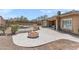 The property features a backyard with a pool, fire pit, and a paved area with ample space for entertaining at 12493 S 179Th Ln, Goodyear, AZ 85338